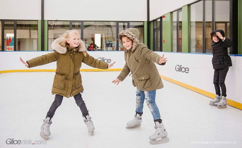 Young girl sskating on a synthetic ice rink