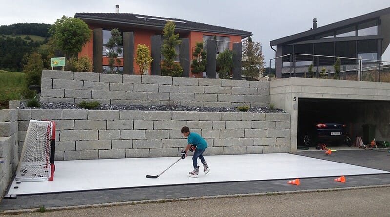 Boy skating on his synthetic ice rink