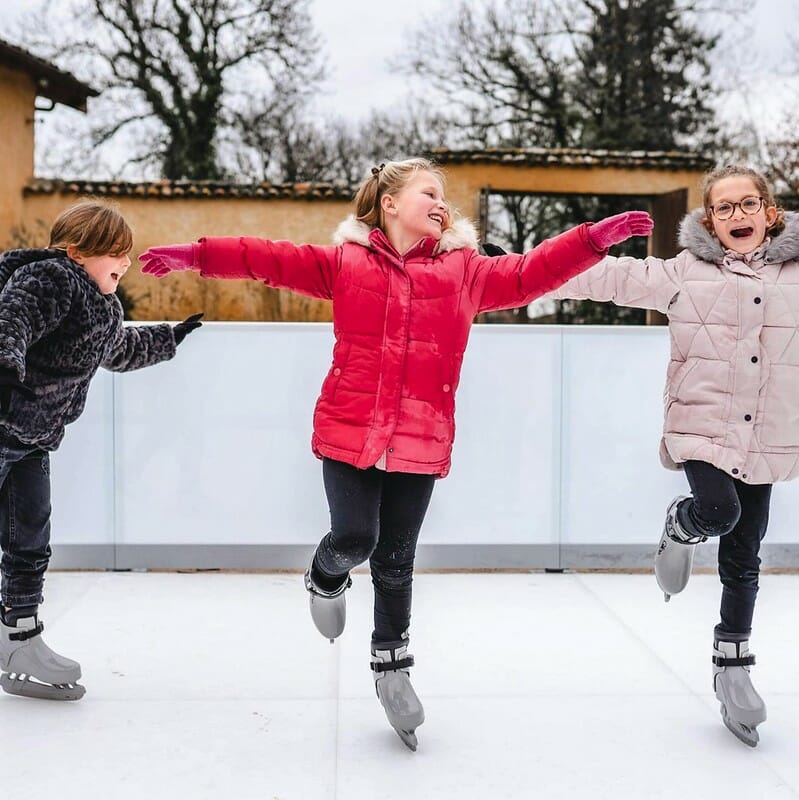 Girls ice skating on synthetic ice