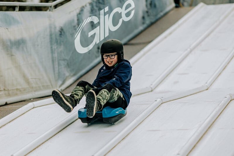 Young boy trying to bobsled